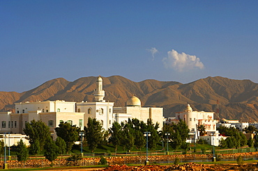 New housing estate with mosque and minaret, in front of stark mountains, Muscat, Sultanate of Oman, Middle East