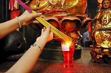 Igniting incense in Phuoc An Hoi Quan Pagoda, Ho Chi Minh City, Saigon, Vietnam, Southeast Asia