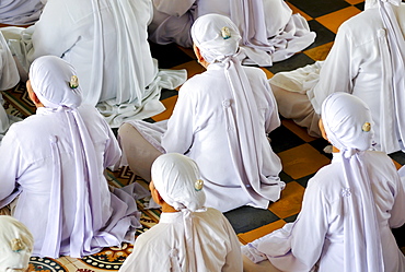 Nuns, ceremonial midday prayer in the Cao Dai temple, Tay Ninh, Vietnam, Asia