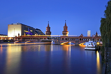 Oberbaumbruecke bridge across the Spree river in the evening in Berlin, Germany, Europe