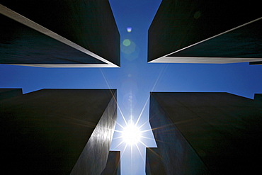 Sun over the concrete slabs or stelae at the Memorial to the Murdered Jews of Europe, Berlin, Germany, Europe