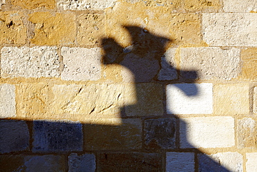 Shadow of a cross on a church wall, Saint-Capraise-de-Lalinde, Dordogne, Aquitaine, France, Europe