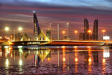 Skyline of the Corniche as seen from King Faisal Highway, Muharraq side, World Trade Center buildings, left, beside the towers of the Financial Harbour Complex, Muharriq Bridge at the Sheikh Isa Causeway, capital city, Manama, Kingdom of Bahrain, Persian 