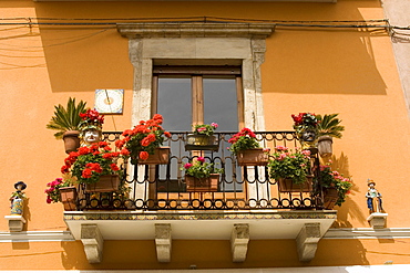 Decorated balcony with flowers by Corso Umberto by Piazza IX Aprile, Taormina, Sicily, Italy