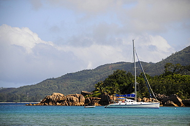 Catamaran in front of granite rocks, Curieuse Island, Seychelles, Africa, Indian Ocean