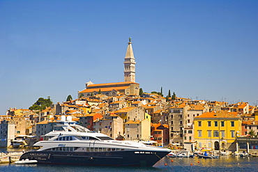 The southern harbour with motor yacht Sibelle against Rovinj historic centre, Istria, Croatia, Europe