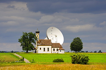 Parabolic antenna at the Erdfunkstelle, station for radio, television and data communications, with a chapel near Raisting, district of Weilheim-Schongau, Bavaria, Germany, Europe