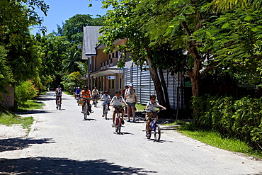 Tourists on bicycles, La Digue Island, Seychelles, Indian Ocean, Africa