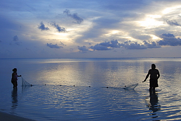 Fishermen at sunset, Aitutaki Atoll, Cook Islands, Pacific Ocean