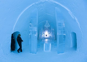 Long hall with a table and a chandelier made of ice, ice hotel of Jukkasjaervi, Lappland, Northern Sweden