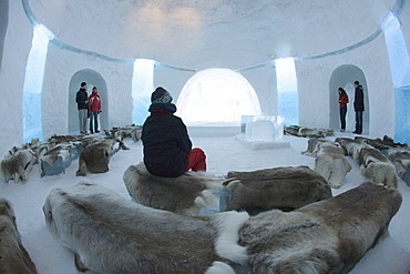 Tourists in the chapel belonging to the ice hotel, Jukkasjaervi, Lappland, Northern Sweden