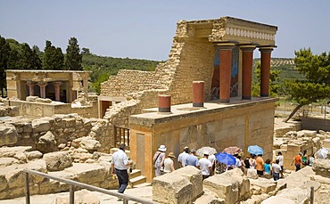 Tourists visiting the arcade of columns at the northern entrance of the palace on the grounds of the Minoan excavation of Knossos, Heraklion, island of Crete, Greece, Europe