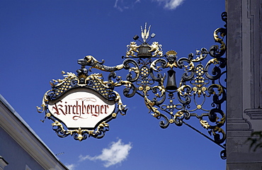 Handcrafted advertising sign of a shop, in a town alley, Bruneck, Val Pusteria, Alto Adige, Italy, Europe