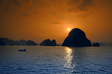 Fishing boat at sunset, Halong Bay, Vietnam, Southeast Asia