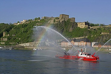 The fire-fighting boat of the fire brigade Koblenz on the Rhine river in front of the Festung Ehrenbreitstein fortress, Koblenz, Rhineland-Palatinate, Germany, Europe