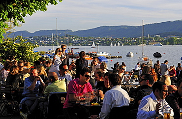 People enjoy a warm spring evening on the lake, Zurich, Switzerland, Europe