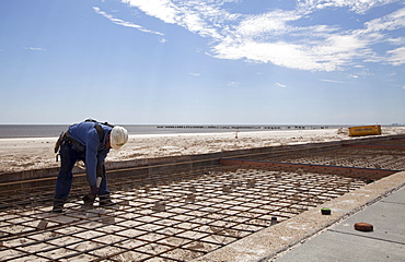 Workers construct a concrete boardwalk along the Gulf of Mexico to replace the boardwalk that was washed away by Hurricane Katrina, Biloxi, Mississippi, USA, Biloxi, Mississippi, USA