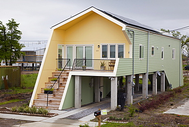 New homes built by Brad Pitt's Make It Right organization in the lower ninth ward which was devastated by Hurricane Katrina; the homes are all elevated and use energy-saving technology and eye-catching design, New Orleans, Louisiana, USA