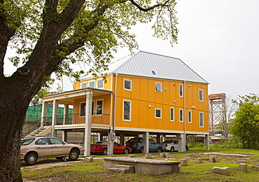 New homes built by Brad Pitt's Make It Right organization in the lower ninth ward which was devastated by Hurricane Katrina; the homes are all elevated and use energy-saving technology and eye-catching design, New Orleans, Louisiana, USA