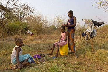 Mother dressing her daughter's hair, African village Sambona, Southern Province, Republic of Zambia, Africa