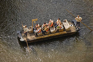 Stirring paddle boot with tourists on River Moldau, &eskË Krumlov, UNESCO World Heritage Site, Czech Republic, Europe