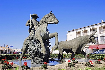 Statue of guardian on Camargue horse beside Camargue bull, Les Saintes-Maries-de-la-Mer, Camargue, Bouches-du-Rhone, Provence-Alpes-Cote d'Azur, Southern France, France, Europe