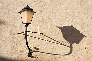 Lamp on Festung Hohensalzburg, the castle of Salzburg, and its shadow on the wall, Austria, Europe