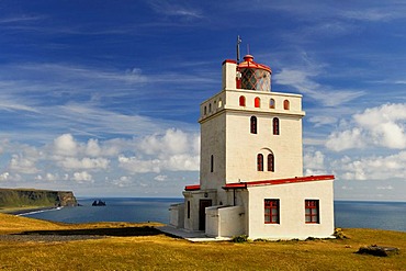 Kap Dyrholaey Lighthouse, to the east the Reynisdrangar, the black rock needles near Vik, South Coast, Iceland, Europe