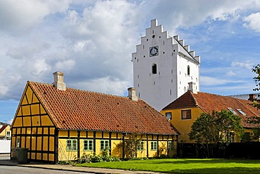 Tower of the Parish Church of St. Maria above a half-timbered house, Saeby, Jutland, Denmark, Europe