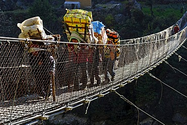 Carriers on Hillary Bridge over Dudh Koshi River, Khumbu Himal, Sagarmatha National Park, Nepal, Asia