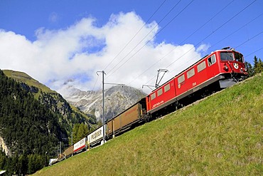 Rhaetische Bahn RhB Railway freight train travelling on the Albula stretch between Berguen and Preda, Graubuenden, Switzerland, Europe