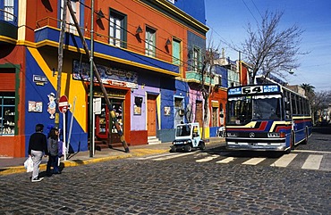 Bus in front of a colourful house facade in the dockland area La Boca, Buenos Aires, Argentina, South America