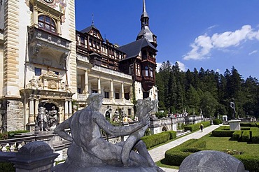 Peles Castle, statue in the foreground, Simiu, Wallachia, Carpathian Mountains, Romania