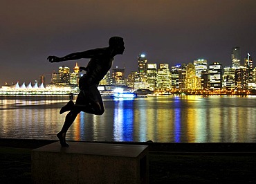 Skyline in front of Coral Harbour, at dusk, and the statue 'the runner', Vancouver, British Columbia, Canada, North America