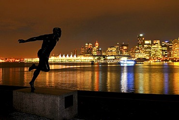 Skyline in front of Coral Harbour, at dusk, and the statue 'the runner', Vancouver, British Columbia, Canada, North America