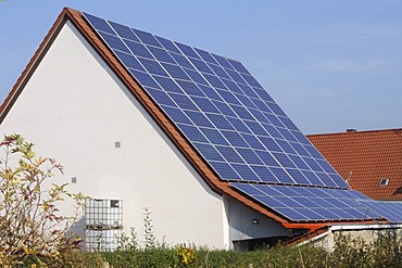 Large roof with with solar collectors in a village