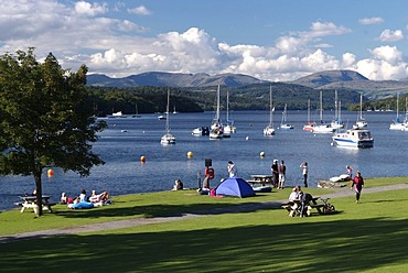 Lake and boats, waterside lawn and people, Lake Windermeere, Lake District, Great Britain, Europe