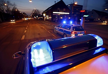 German police cars, blue design, in action with flashing sirens