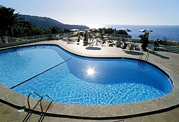 Pool with a reflection of the sun, view towards the sea, Hotel Costa d'Or, Deia, Serra de Tramuntana, Majorca, Balearic Islands, Spain, Europe