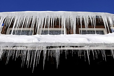 Icicles hanging from a roof gutter