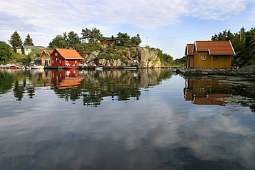 Traditionally built red houses in a fjord near Avik, Norway, Scandinavia, Europe