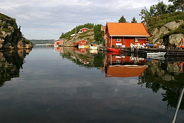 Traditionally built red houses in a fjord near Avik, Norway, Scandinavia, Europe