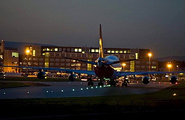 Boeing 747 being towed over the taxiway, evening light