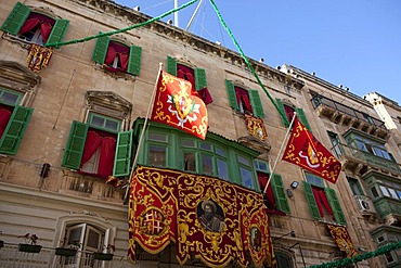 House decorated with traditional Maltese flags on Republic Street, Valletta, Malta, Europe