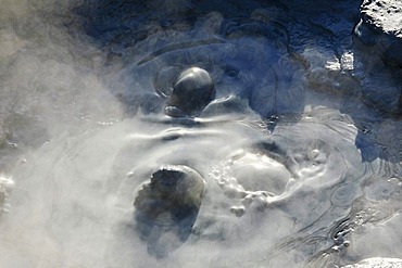 Hot, bubbling mud in a pool in the Gunnuhver geothermal area, Iceland, Europe