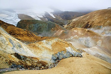 Hills coloured by minerals and colourful Rhyolith Mountains below the Kerlingarfjoell Glacier, criss-crossed by streams, Iceland, Europe