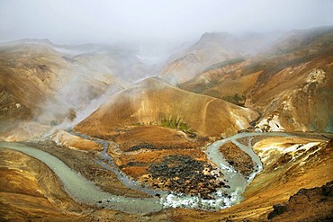 Hills coloured by minerals and colourful Rhyolith Mountains below the Kerlingarfjoell Glacier, criss-crossed by streams, Iceland, Europe