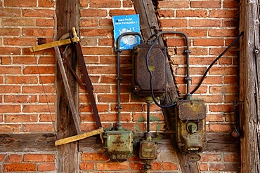 Old connection box and a handsaw on a timber-framed wall, Neso, Mecklenburg Western-Pomerania, Germany, Europe