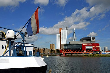 Inland navigation ship in the Rijnhaven, in front of modern architecture at the Wilhelminapier, Wilhelminaplein: the Luxor theatre, to the left of it the Belvedere building of the telephone company KPN Telecom and behind it the Erasmusbrug bridge, Rotterd