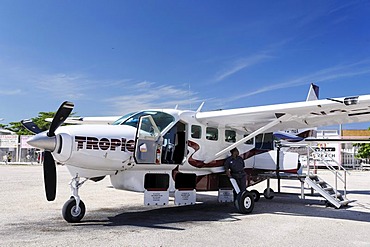 Cessna 208 Caravan with open baggage compartments, Tropic Air, on the local airfield of San Pedro, Ambergris Cay Island, Belize, Central America, Caribbean